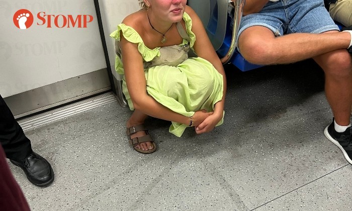 MRT train woman urinating